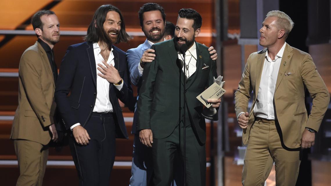 Whit Sellers, from left, Geoff Sprung, Brad Tursi, Matthew Ramsey and Trevor Rosen, of Old Dominion, accept the award for vocal group of the year at the 53rd annual Academy of Country Music Awards April 15, 2018, in Las Vegas. The band will open for Kenny Chesney’s Trip Around the Sun tour stop at Raleigh’s Coastal Credit Union Music Park at Walnut Creek this Saturday.