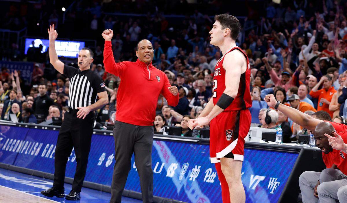 N.C. State head coach Kevin Keatts celebrates after Michael O’Connell (12) made a three-pointer at the end of regulation to tie the game during N.C. State’s 72-65 overtime victory over Virginia in the semifinals of the 2024 ACC Men’s Basketball Tournament at Capital One Arena in Washington, D.C., Friday, March 15, 2024.
