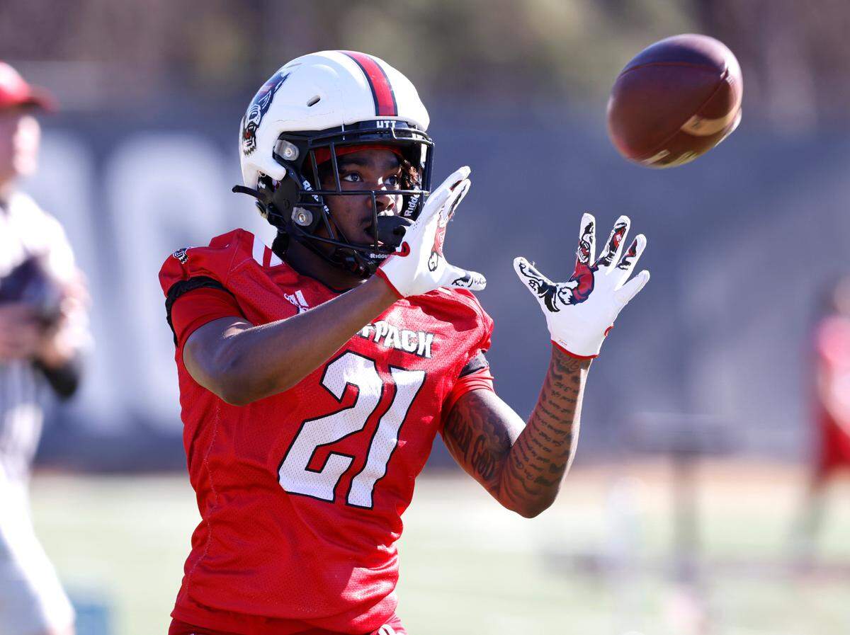 N.C. State wide receiver Jalen Coit (21) pulls in a pass during the first day of the Wolfpack’s spring football practice in Raleigh, N.C., Wednesday, March 2, 2022.