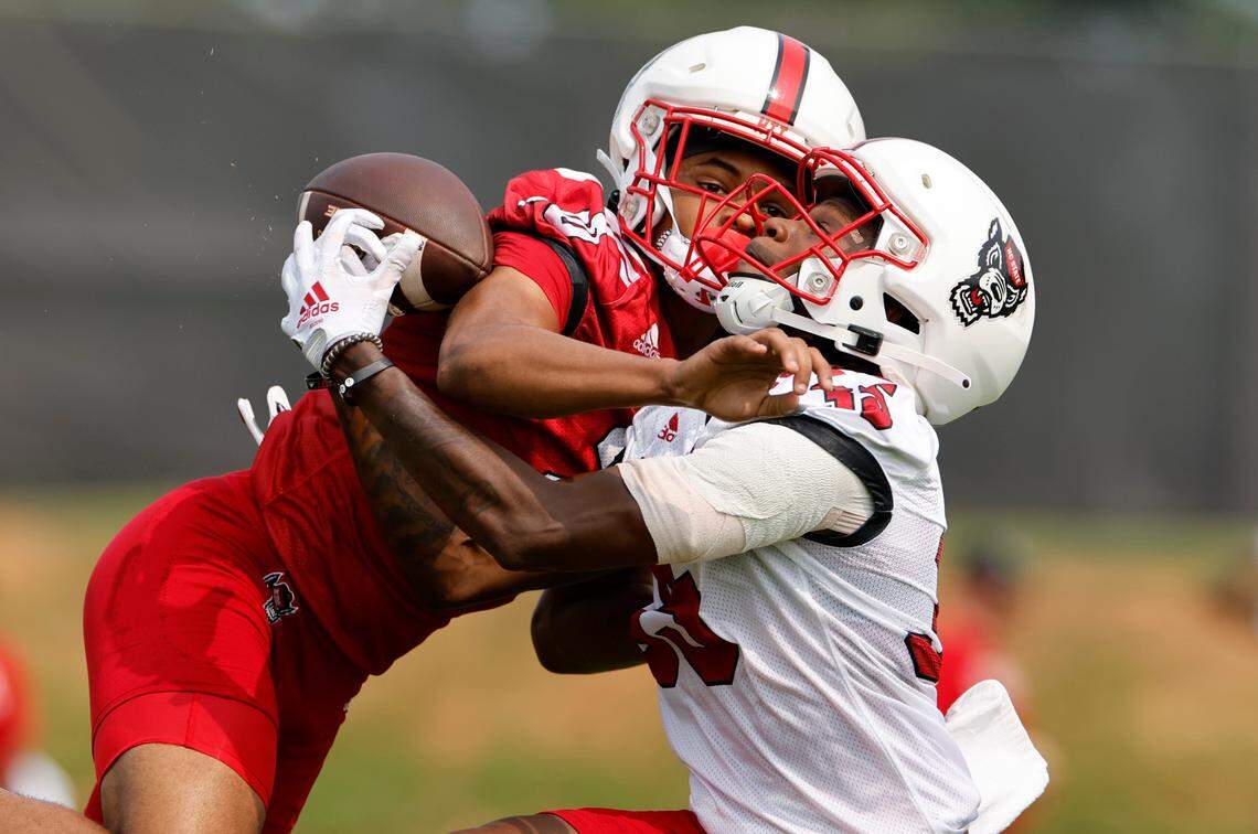 N.C. State wide receiver Christopher Scott Jr. (35) fights to pull in a pass as N.C. State safety Daemon Fagan (20) defends during the Wolfpack’s first fall practice in Raleigh, N.C., Wednesday, August 2, 2023.