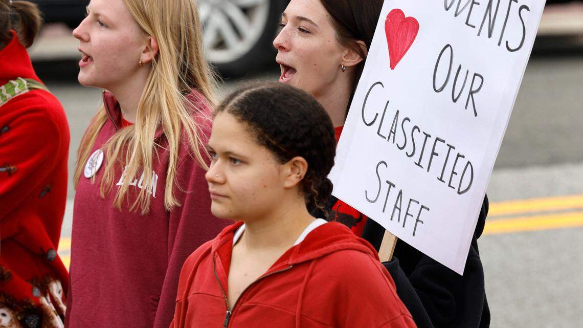 Jordan High School seniors, clockwise from left, Angie Bean-Ross, Avari Clark and Emma Fisher march around the Durham Public Schools administrative building during a protest in Durham, N.C., Wednesday, Jan. 31, 2024. Twelve Durham public schools were closed Wednesday as staff — furious about unresolved salary issues — called in sick to attend protests.