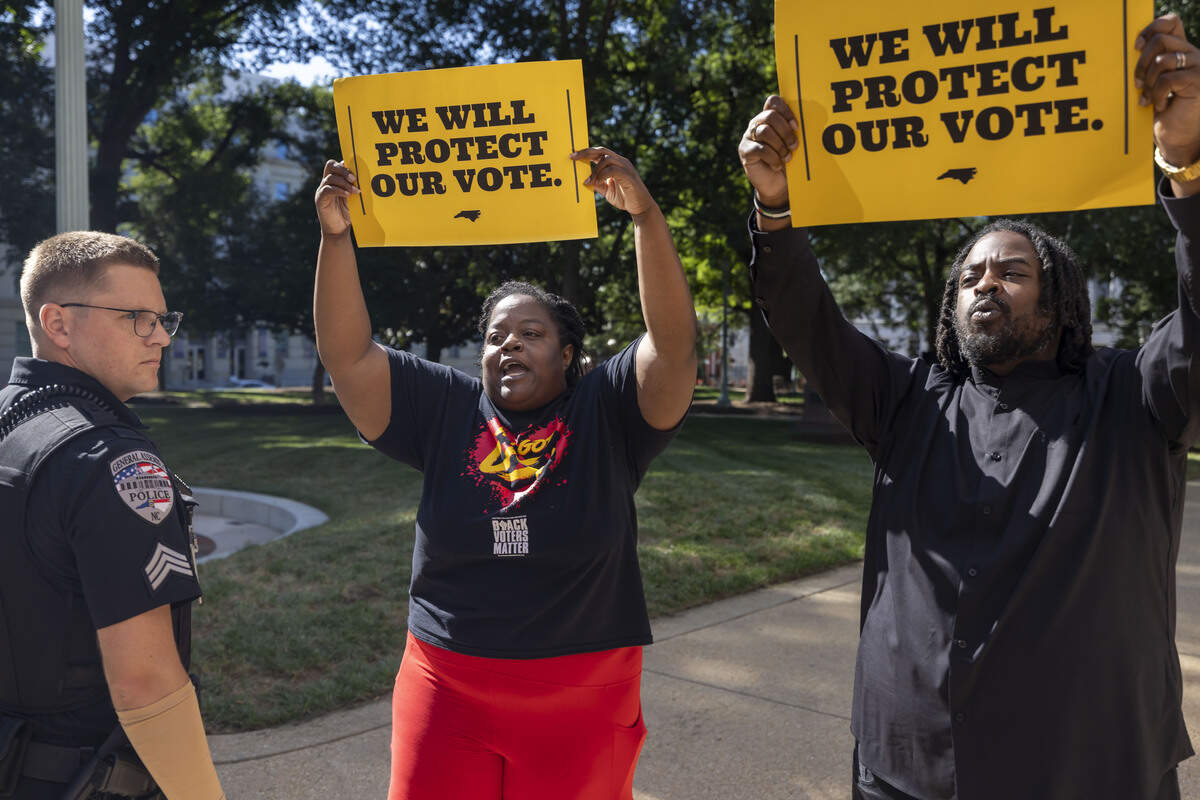 Wanda Hunter and Marcus Bass demonstrate outside the State Capitol, calling on North Carolina senators, entering the historic building for a meeting, to pass a budget on Tuesday, June 30, 2026 in Raleigh, N.C.