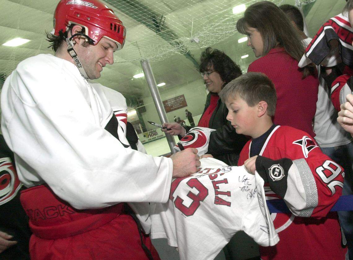 Brandon Goodwin, 9, gets an autograph from one of heroes Bates Battaglia as he comes off ice after practice at the Rec Zone in May 2002.