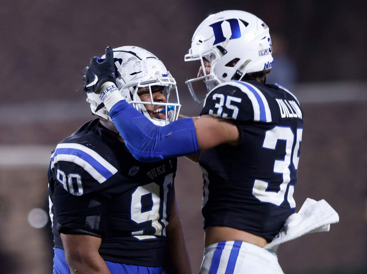 Duke’s DeWayne Carter celebrates with Cam Dillon after sacking Wake Forest quarterback Sam Hartman during the second half of the Blue Devils’ final regular season game at Wallace Wade Stadium on Saturday, Nov. 26, 2022, in Durham, N.C.