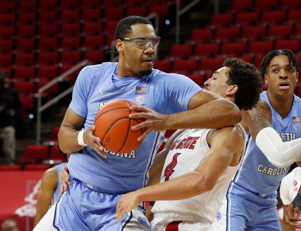 North Carolina’s Garrison Brooks (15) is called for the offensive foul on N.C. State’s Jericole Hellems (4) during the first half of N.C. State’s game against UNC at PNC Arena in Raleigh, N.C., Tuesday, December 22, 2020.