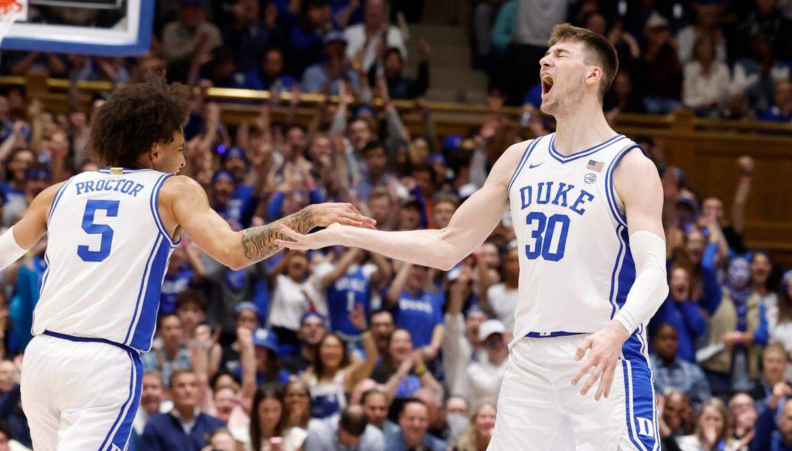 Duke’s Kyle Filipowski (30) celebrates with Tyrese Proctor (5) after hitting a three-pointer during the first half of Duke’s game against Virginia at Cameron Indoor Stadium in Durham, N.C., Saturday, March 2, 2024.