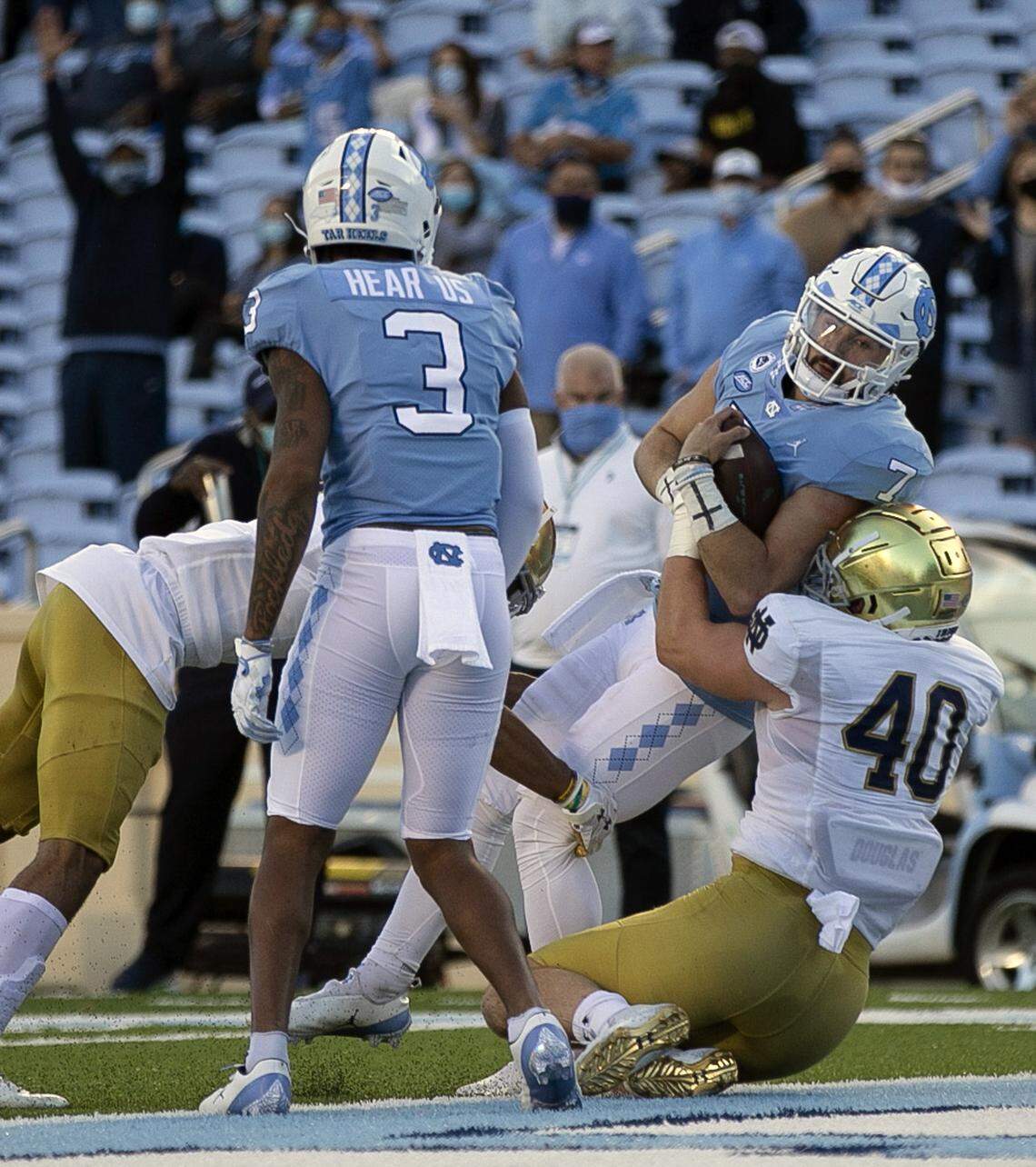North Carolina quarterback Sam Howell (7) scores on one-yard carry to give the Tar Heels’ a 14-7 lead in the first quarter against Notre Dame’s Drew White (40) on Friday, November 27, 2020 at Kenan Stadium in Chapel Hill, N.C.