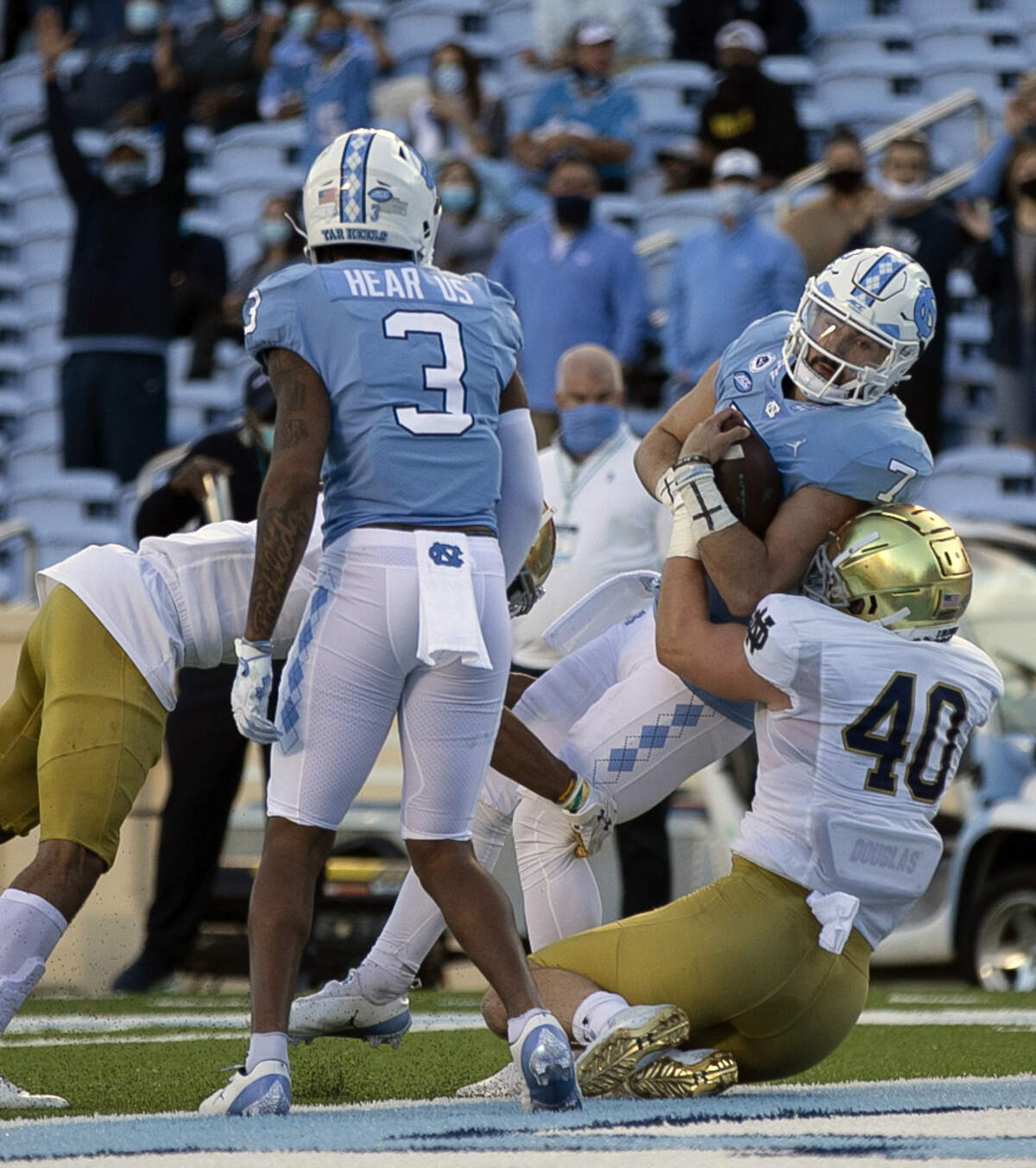 North Carolina quarterback Sam Howell (7) scores on one-yard carry to give the Tar Heels’ a 14-7 lead in the first quarter against Notre Dame’s Drew White (40) on Friday, November 27, 2020 at Kenan Stadium in Chapel Hill, N.C.