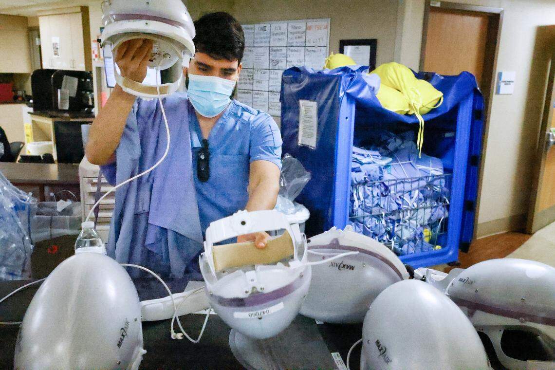 Eric Gonzalez, RN, prepares to put on protective gear before entering the COVID patient care area of the Medical Intensive Care Unit at UNC Hospital in Chapel Hill, N.C., on Wednesday, Aug. 11, 2021.