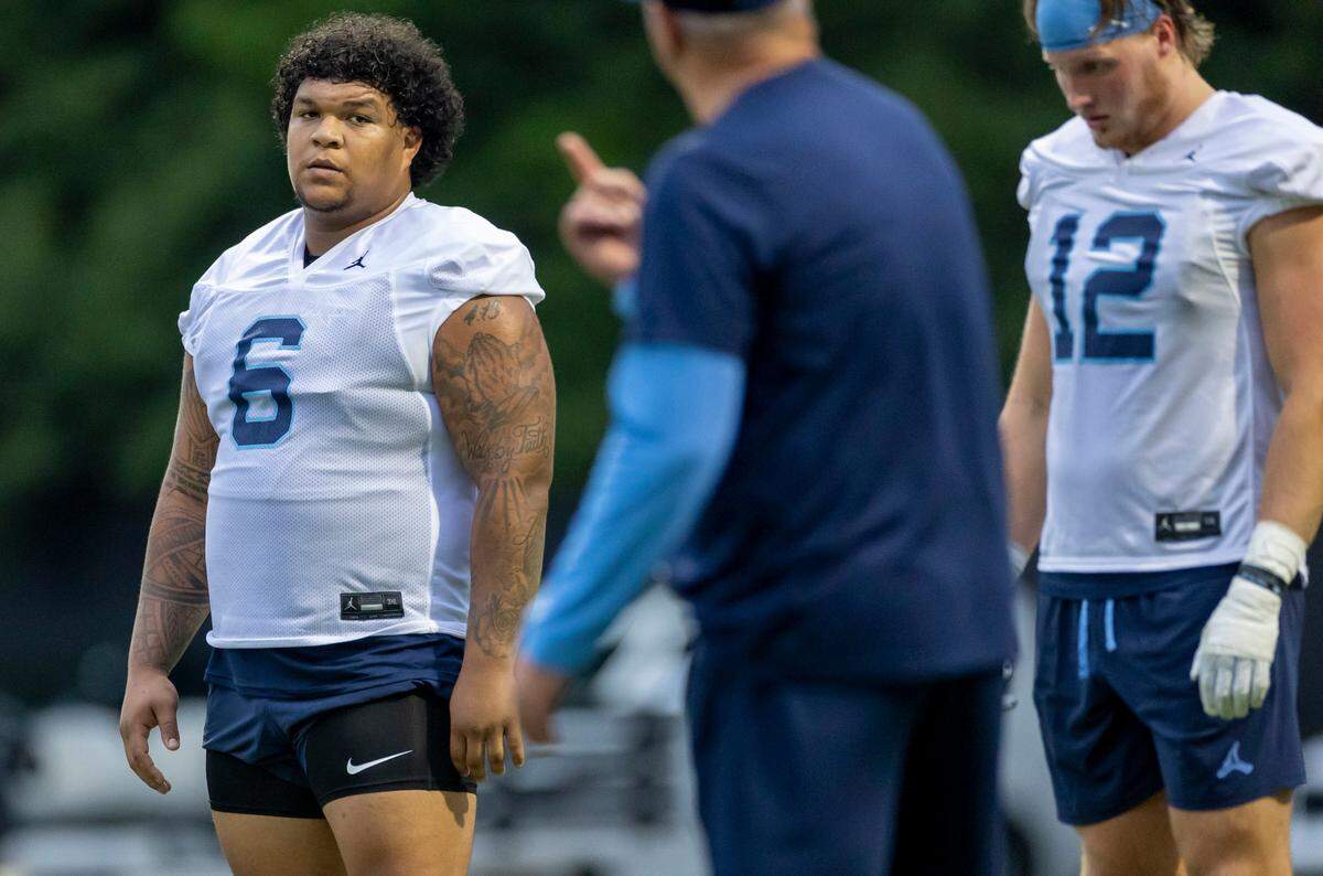 North Carolina defensive lineman Joshua Harris Sr. (6) listens to coach Ted Monachino during the Tar Heels’ first practice of the season on Monday, July 29, 2024 in Chapel Hill, N.C.