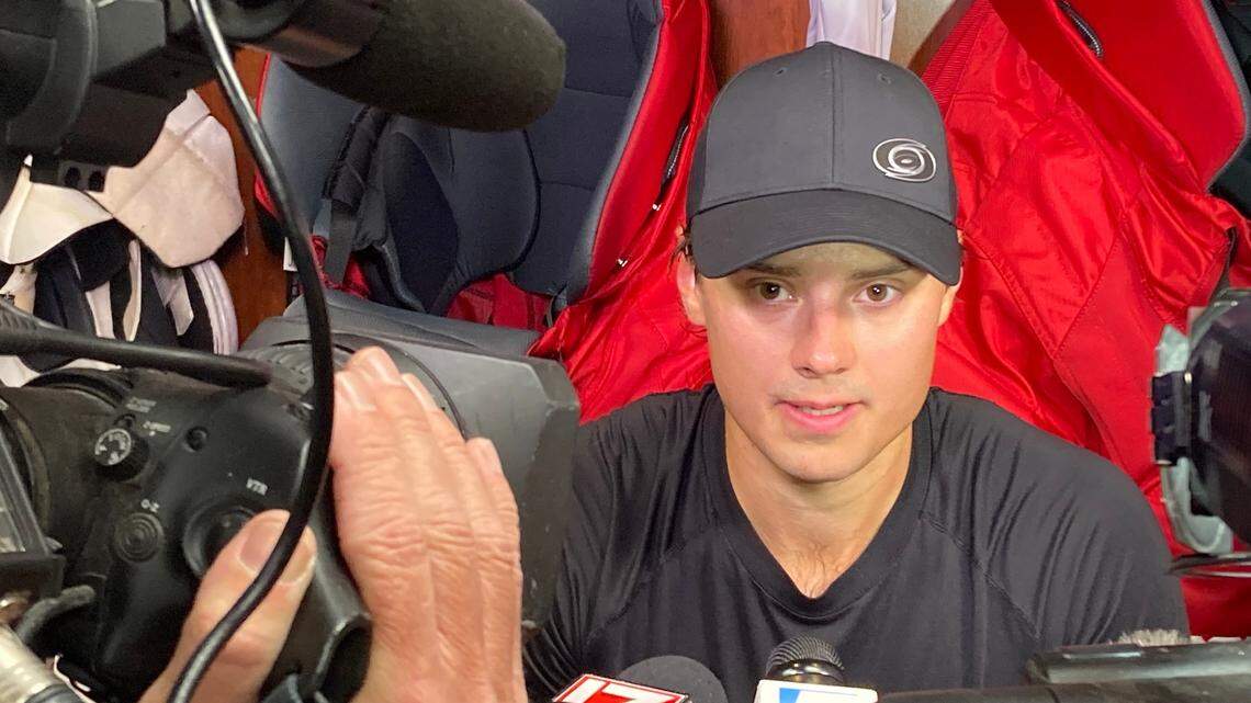 Carolina Hurricanes center Sebastian Aho is surrounded by media after the first on-ice session of preseason training camp Sept. 21, 2023 at PNC Arena.