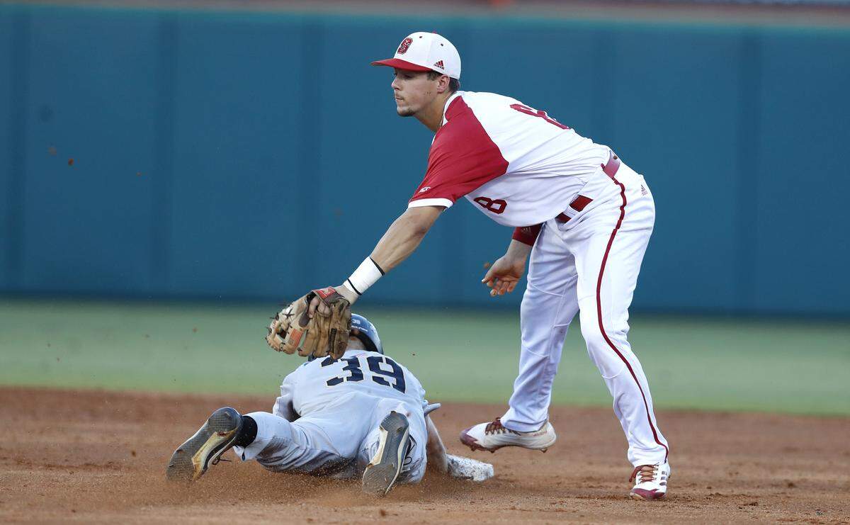 Army's Jacob Hurtubise (39) steals second as N.C. State's Will Wilson (8) makes the tag during Army's 5-1 victory over the Wolfpack in the Raleigh Regional at Doak Field Friday, June 1, 2018.