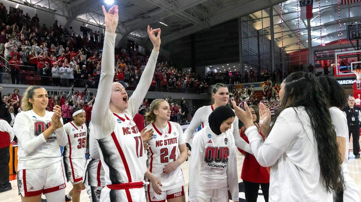 NC State’s freshman Maddie Cox (11) celebrates with teammates after the Wolpack’s 79-72 win against Tennessee during the second round of the Division I Women’s Basketball Championship at Reynolds Coliseum in Raleigh, on March 25, 2024. The Wolfpack won 79-72.