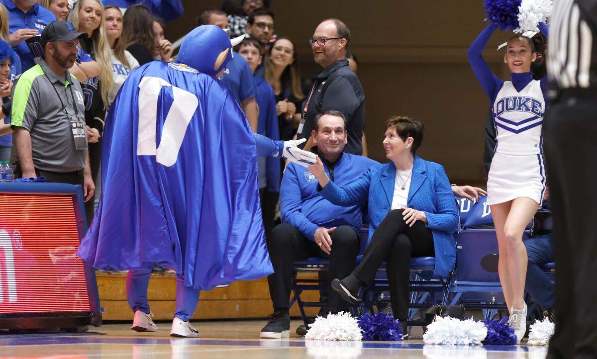 Mickie Krzyzewski greets the Blue Devil as her husband former head coach Mike Krzyzewski sits next to her during the second half of Duke’s 68-64 victory over Notre Dame at Cameron Indoor Stadium in Durham, N.C., Tuesday, Feb. 14, 2023.