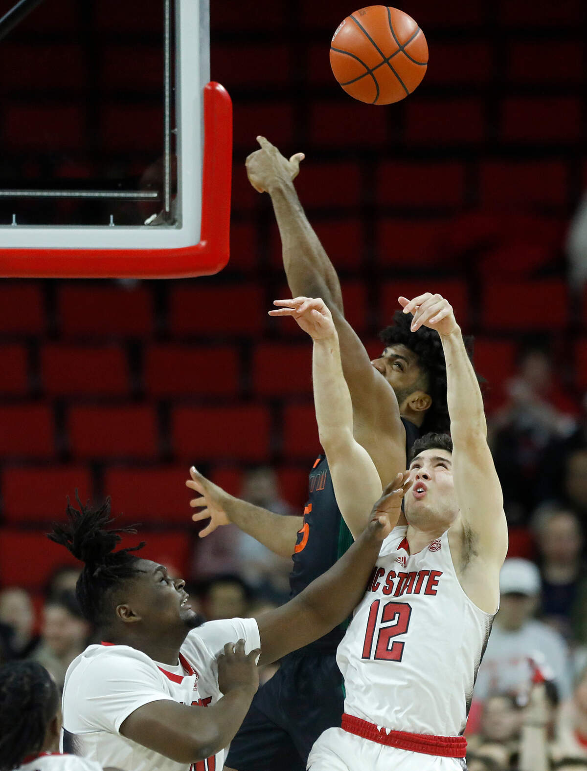 N.C. State’s DJ Burns Jr. and Michael O’Connell battle for a loose ball during the first half of the Wolfpack’s game on Tuesday, Jan. 30, 2024, at PNC Arena in Raleigh, N.C.