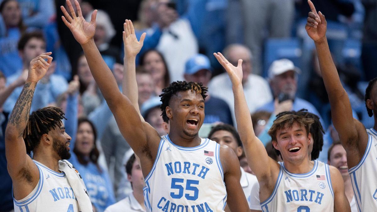 North Carolina’s Harrison Ingram (55) leads the celebration on the Tar Heels’ bench after James Okonkwo (32) hit a free-throw to break the century mark as North Carolina rolled to a 103-67 victory over Syracuse on Saturday, January 13, 204 at the Smith Center in Chapel Hill, N.C.