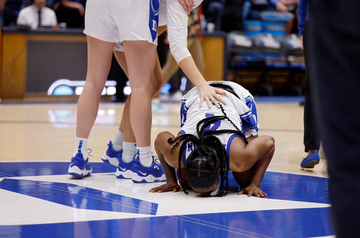 Duke’s Elizabeth Balogun kneels at center court following the Blue Devils’ 61-53 loss to Colorado in an NCAA Tournament second round game at Cameron Indoor Stadium on Monday, March 20, 2023, in Durham, N.C.