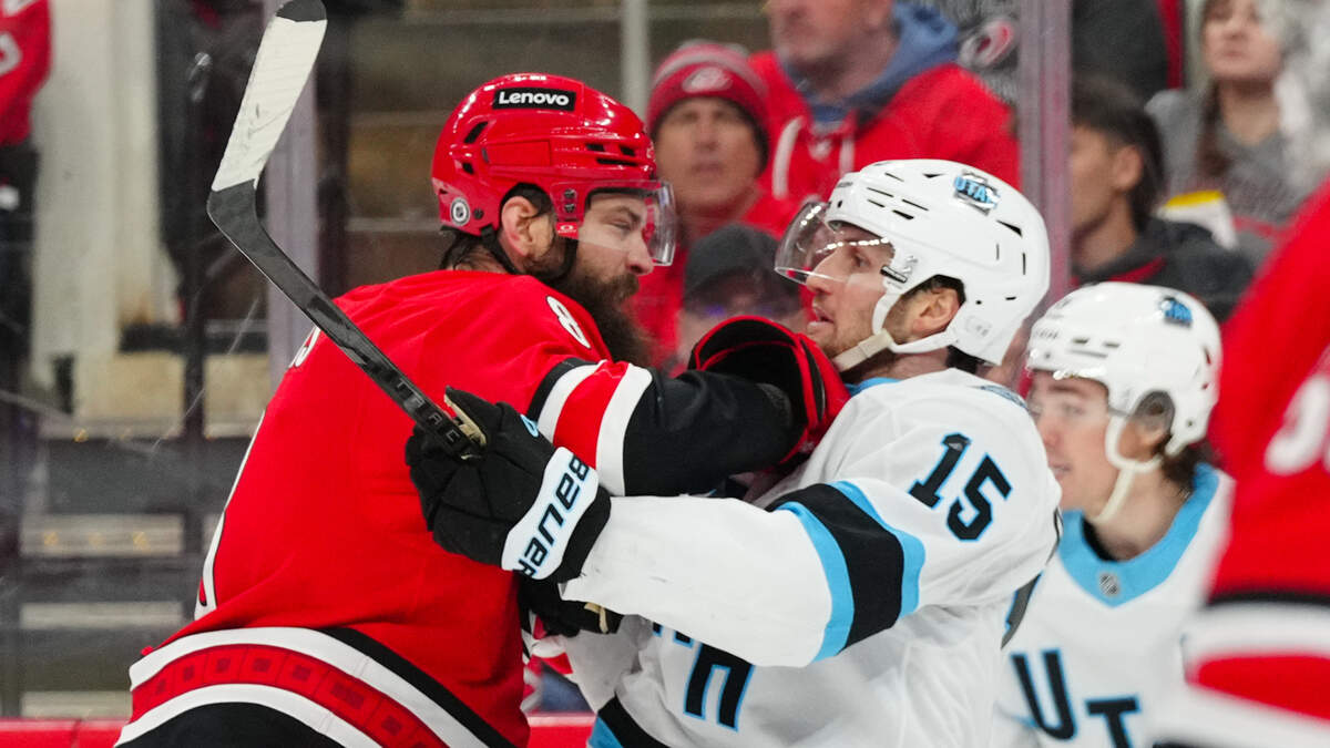 Carolina Hurricanes defenseman Brent Burns (8) goes after Utah Hockey Club center Alexander Kerfoot (15) during the second period at Lenovo Center on Saturday, Feb. 8, 2025.