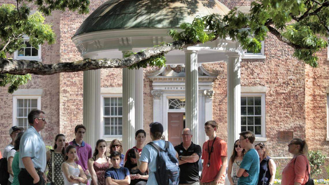 A tour group of parents, future students and family members learn the history of UNC’s Old Well on the Chapel Hill campus in 2016.