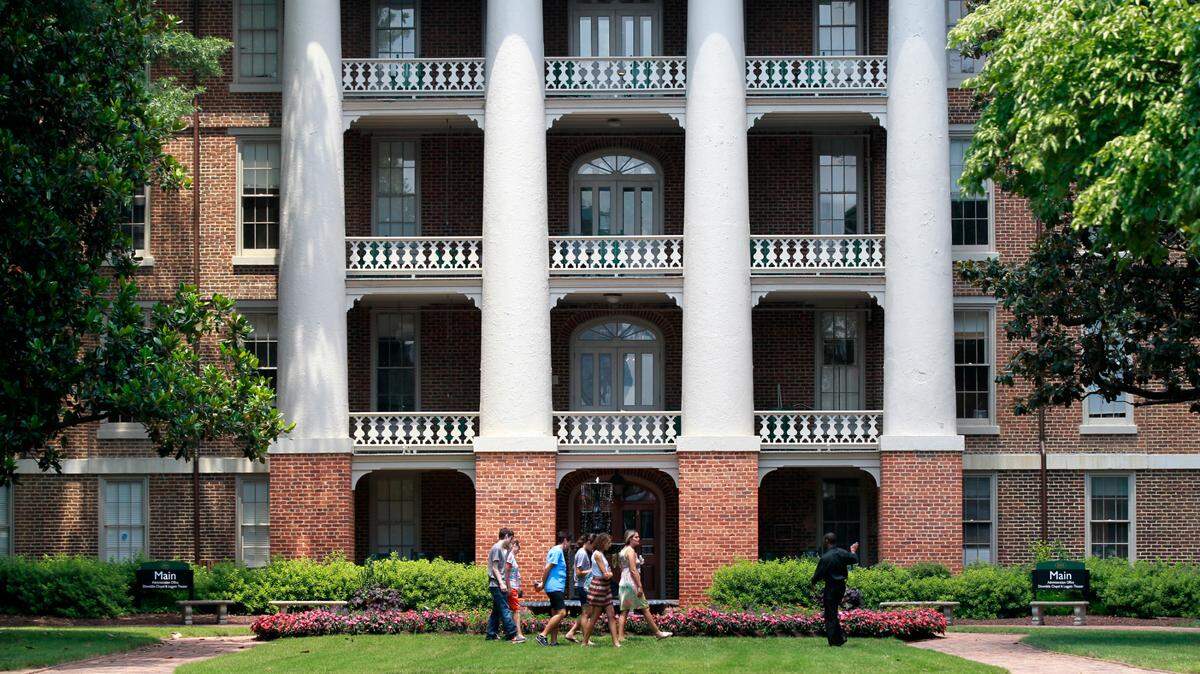 In this July 2013 file photo, a tour passes by William Peace University’s Main Building. William Peace University was among a number of area schools that received a Paycheck Protection Program loan.