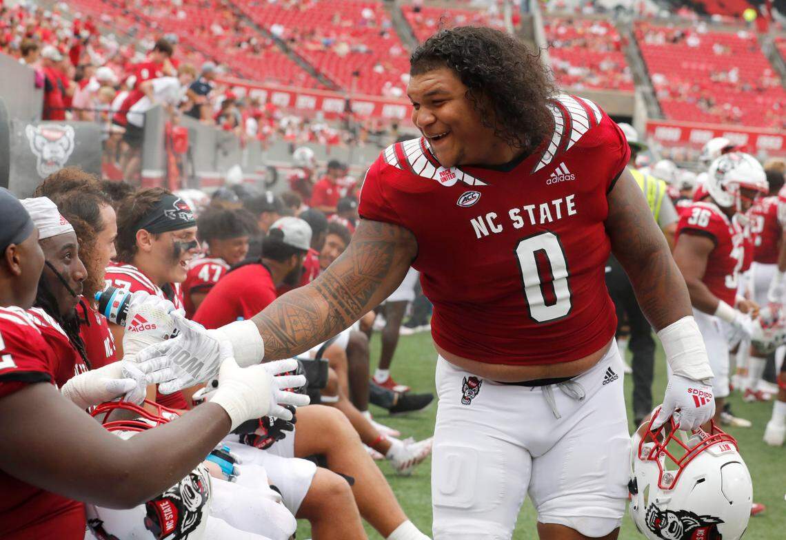 N.C. State’s Joshua Harris (0) laughs with Timothy McKay (52) during the second half of N.C. State’s 55-3 victory over Charleston Southern at Carter-Finley Stadium in Raleigh, N.C., Saturday, Sept. 10, 2022.