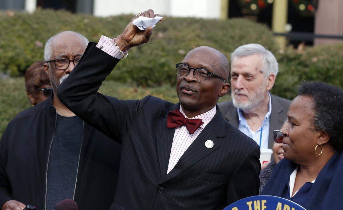 Rev. T. Anthony Spearman, president of the NC NAACP, crumples up a mailer that tells voters IDs are needed in the upcoming 2020 election during a press conference outside the Legislative Building in Raleigh, N.C., Friday, Dec. 27, 2019. The press conference was held after a federal judge in North Carolina said Thursday she would block the NC voter ID law, at least temporarily, as a lawsuit against the state continues.
