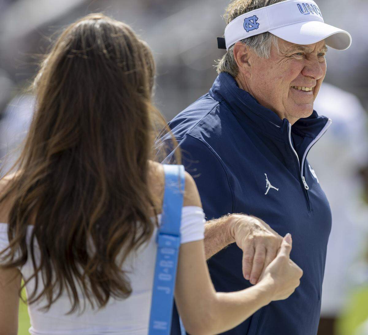 Jordan Hudson talks with North Carolina coach Bill Belichick prior to the Tar Heels’ game against UCF on Saturday, September 20, 2025 at Acrisure Bounce House Stadium in Orlando, Fla.