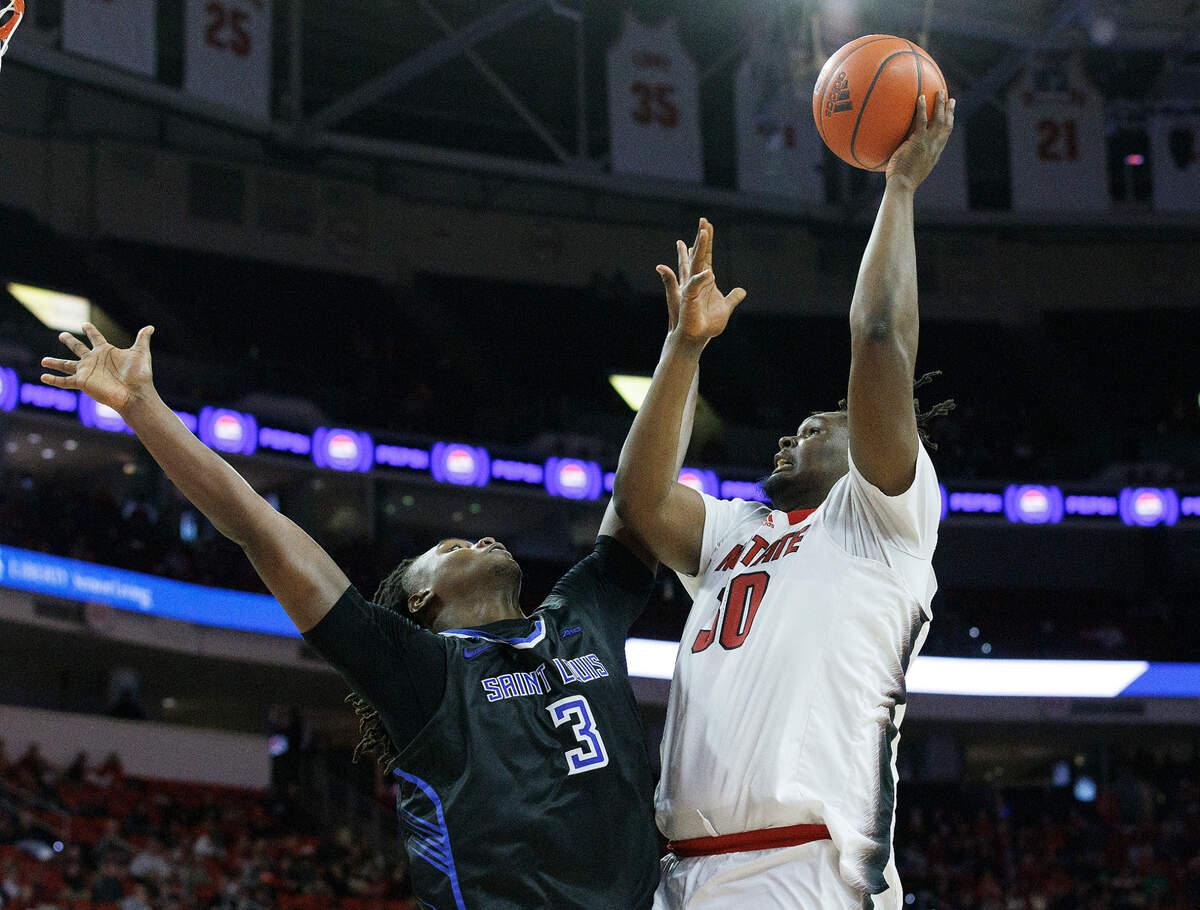 N.C. State’s DJ Burns Jr. shoots over Saint Louis’ Bradley Ezewiro during the second half of the Wolfpack’s 82-70 win on Wednesday, Dec. 20, 2023, at PNC Arena in Raleigh, N.C.