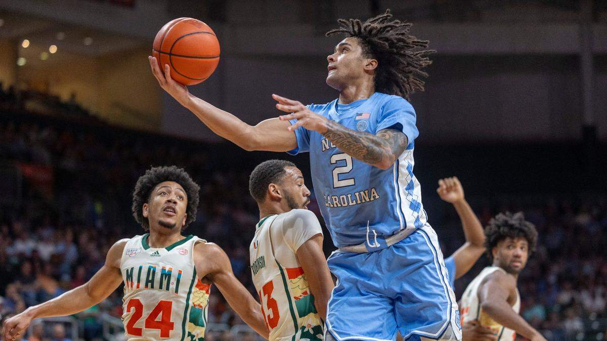 North Carolina’s Elliot Cadeau (2) drives to the basket against Jakai Robinson (13) in the first half on Saturday, February 10, 2024 at the Watsco Center in Coral Gables, Florida. Cadeau scored 11 points in the first half.