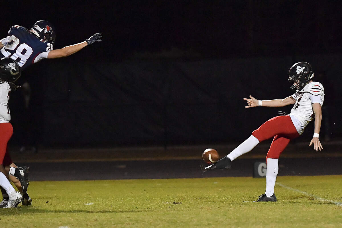 Apex Friendship linebacker Tobin Stam (28) leaps to attempt to block the punt from Rolesville kicker Riley Daniels  (36) during the first half. The Apex Friendship Patriots and the Rolesville Rams met in  the second round of the  NCHSAA 8A Playoff game in Apex, N.C. on November 14, 2025. Rolesville wins 14-7 in overtime.