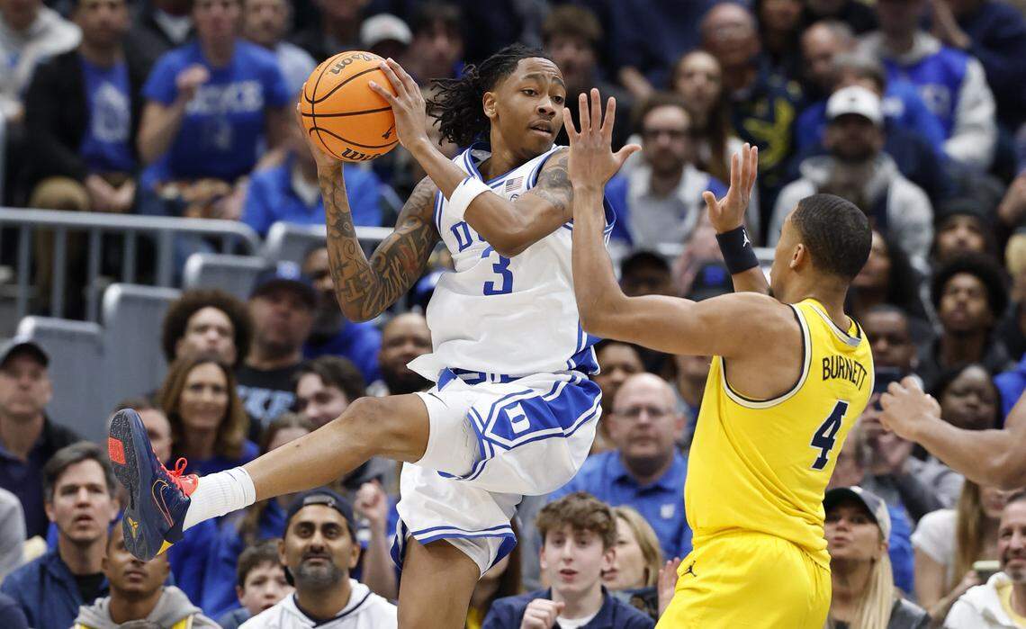 Duke’s Isaiah Evans (3) saves the ball from going out of bounds defended by Michigan's Nimari Burnett (4) during the first half of Duke’s game against Michigan in the Capital Showcase at Capital One Arena in Washington, D.C., Saturday, Feb. 21, 2026.