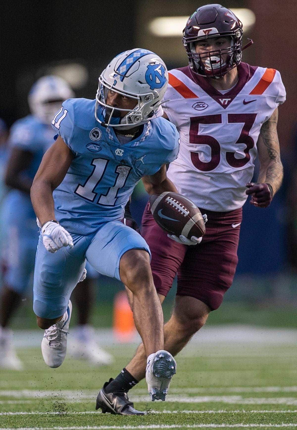 North Carolina wide receiver Josh Downs (11) picks up 33-yard on a pass completion from quarterback Drake Maye in the third quarter ahead of Virginia Tech’s Will Johnson (53) on Saturday, October 1, 2022 at Kenan Stadium in Chapel Hill, N.C.