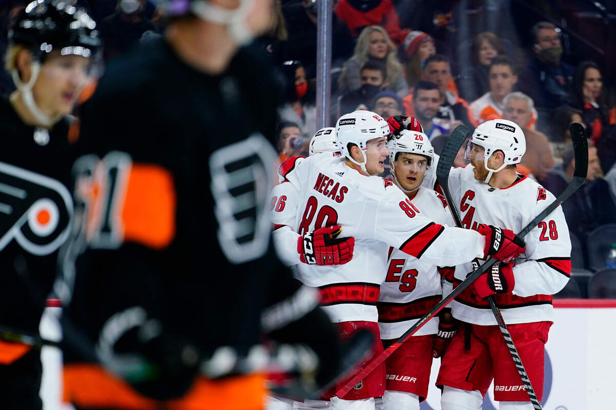 Carolina Hurricanes’ Sebastian Aho (20) celebrates with teammates after scoring a goal during the first period of an NHL hockey game against the Philadelphia Flyers, Friday, Nov. 26, 2021, in Philadelphia. (AP Photo/Matt Slocum)