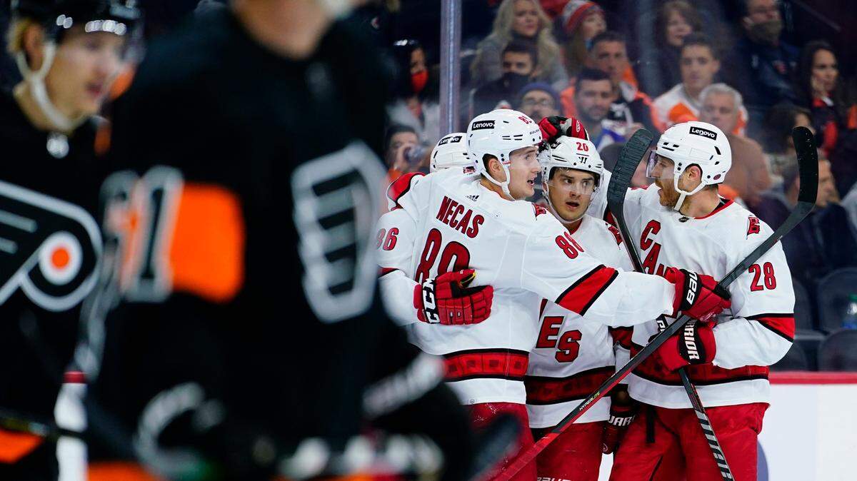 Carolina Hurricanes’ Sebastian Aho (20) celebrates with teammates after scoring a goal during the first period against the Philadelphia Flyers on Nov. 26, 2021, in Philadelphia. The Canes-Flyers game scheduled for Tuesday was postponed.