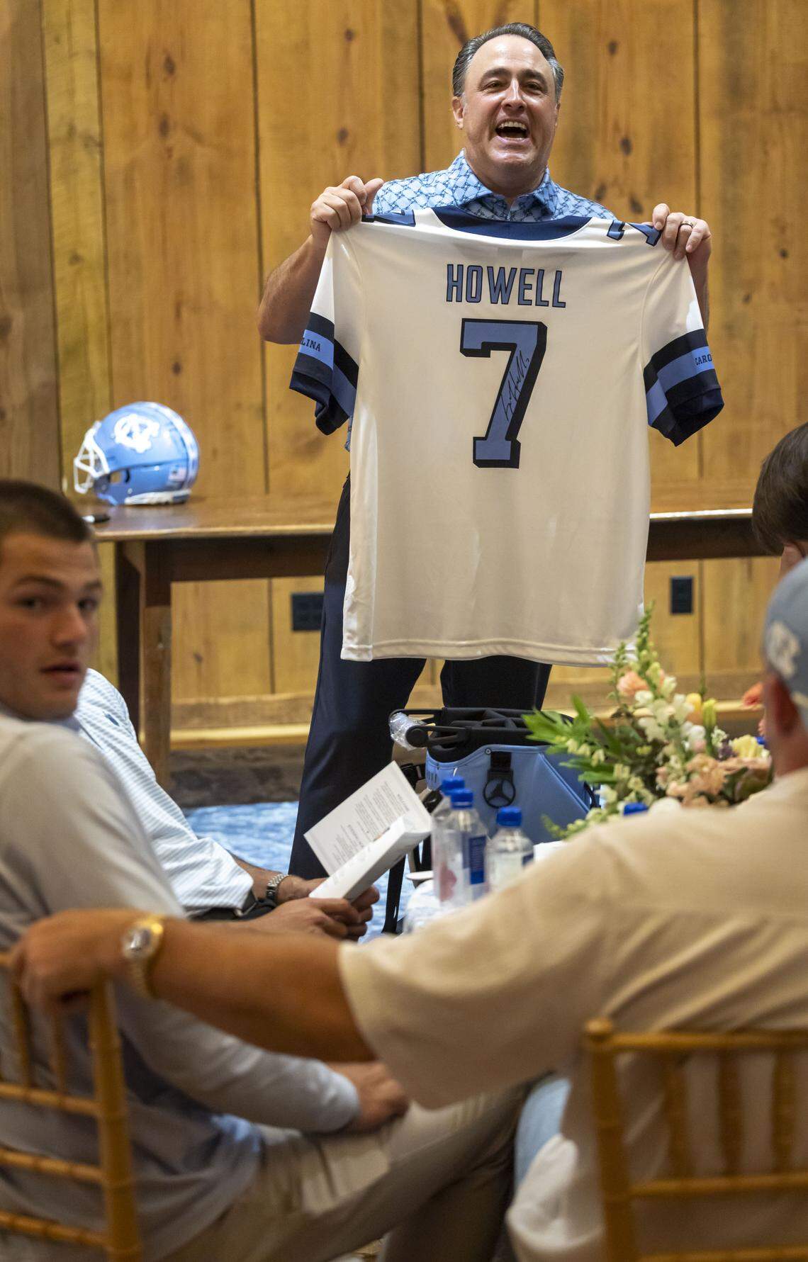 Vaughn Moore displays a North Carolina jersey autographed by Sam Howell, up for sale at auction, during a fundraiser auction for TABLE on Friday, April 17, 2026 in Carrboro, N.C.