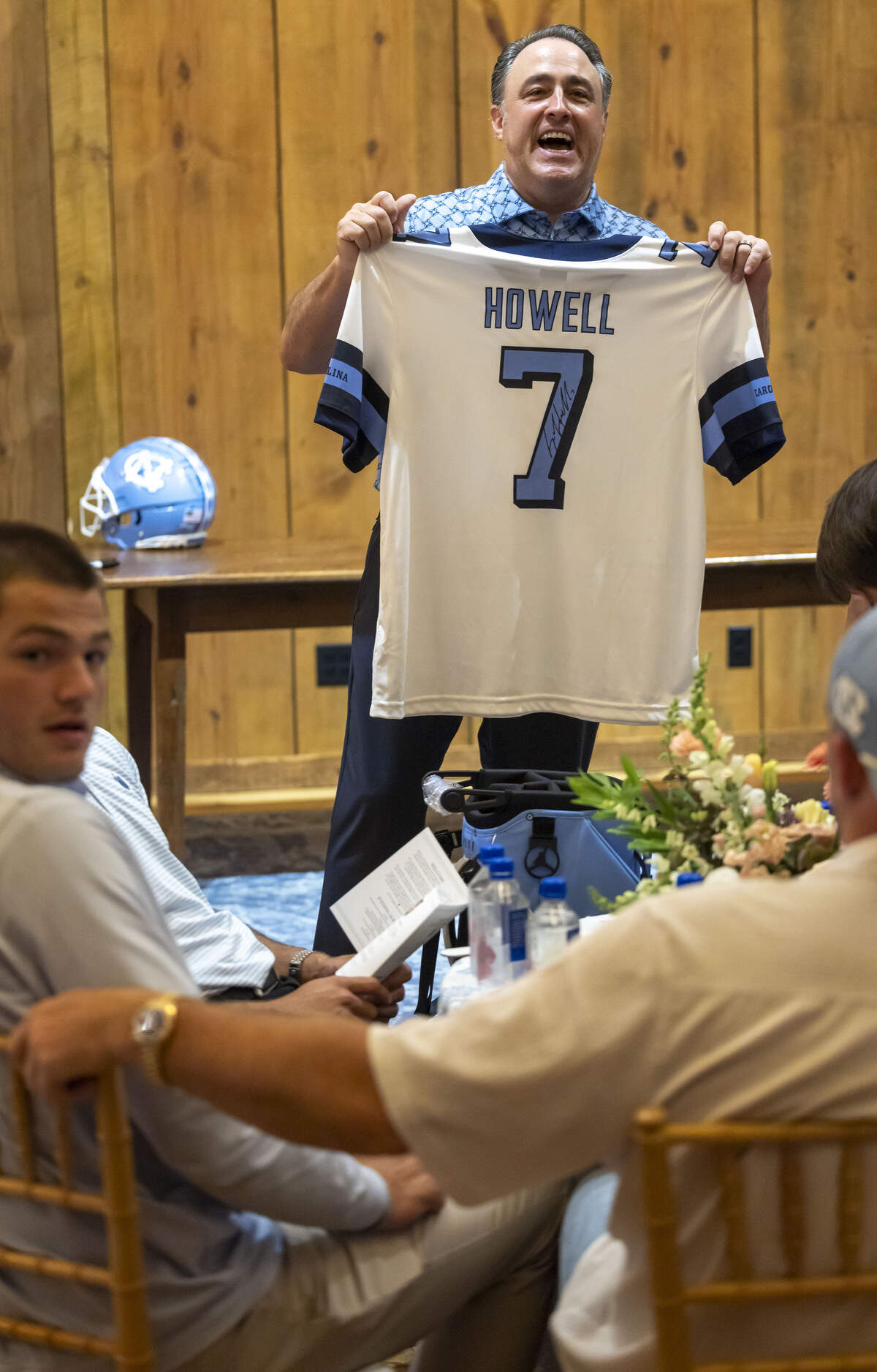 Vaughn Moore displays a North Carolina jersey autographed by Sam Howell, up for sale at auction, during a fundraiser auction for TABLE on Friday, April 17, 2026 in Carrboro, N.C.