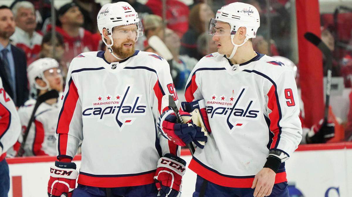 Washington Capitals center Evgeny Kuznetsov (92) and Washington Capitals defenseman Dmitry Orlov (9) talk while playing against the Carolina Hurricanes at PNC Arena in 2019.
