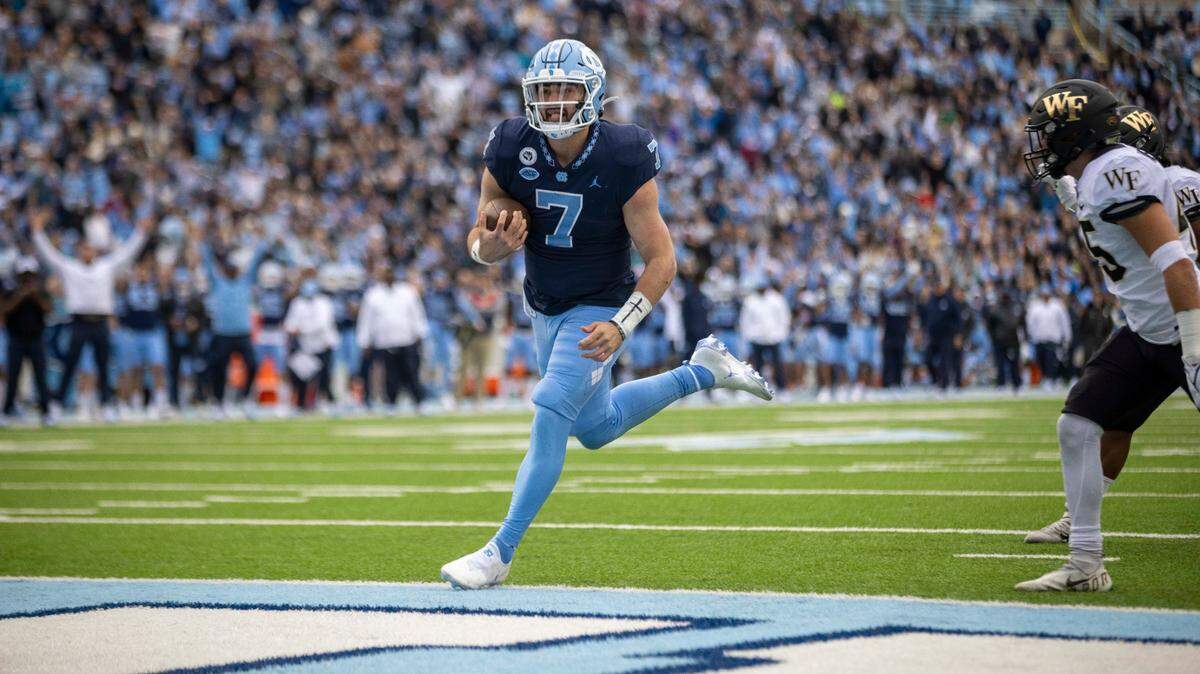 North Carolina quarterback Sam Howell (7) scores a touchdown on an 12-yard run in the first quarter to give the Tar Heels a 14-10 lead over Wake Forest on Saturday, November 6, 2021 at Kenan Stadium in Chapel Hill, N.C.