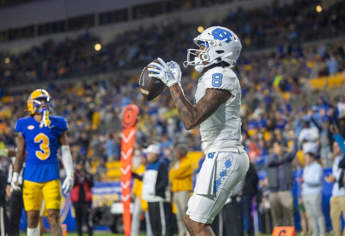 North Carolina’s Kobe Paysour (8) reacts after scoring on a 7-yard pass reception from quarterback Drake Maye in the second quarter to give the Tar Heels a 28-17 lead against Pitt on Saturday, September 23, 2023 at Acrisure Stadium in Pittsburgh, Pa.