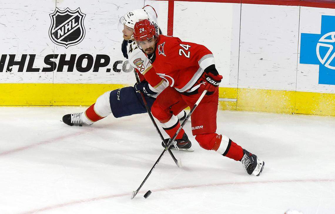 Carolina center Seth Jarvis (24) keeps the puck from Florida defenseman Gustav Forsling (42) during the second period of game two between the Hurricanes and Panthers in the Eastern Conference Finals at PNC Arena in Raleigh, N.C., Saturday, May 20, 2023.