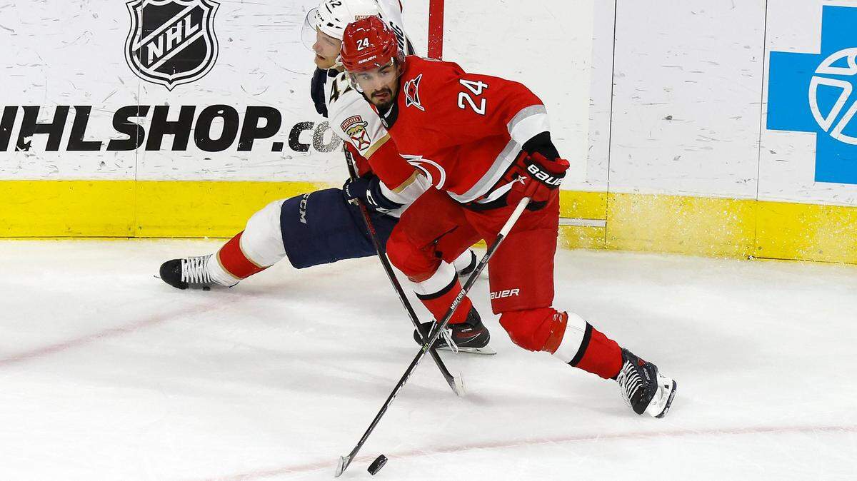 Carolina center Seth Jarvis (24) keeps the puck from Florida defenseman Gustav Forsling (42) during the second period of game two between the Hurricanes and Panthers in the Eastern Conference Finals at PNC Arena in Raleigh, N.C., Saturday, May 20, 2023.
