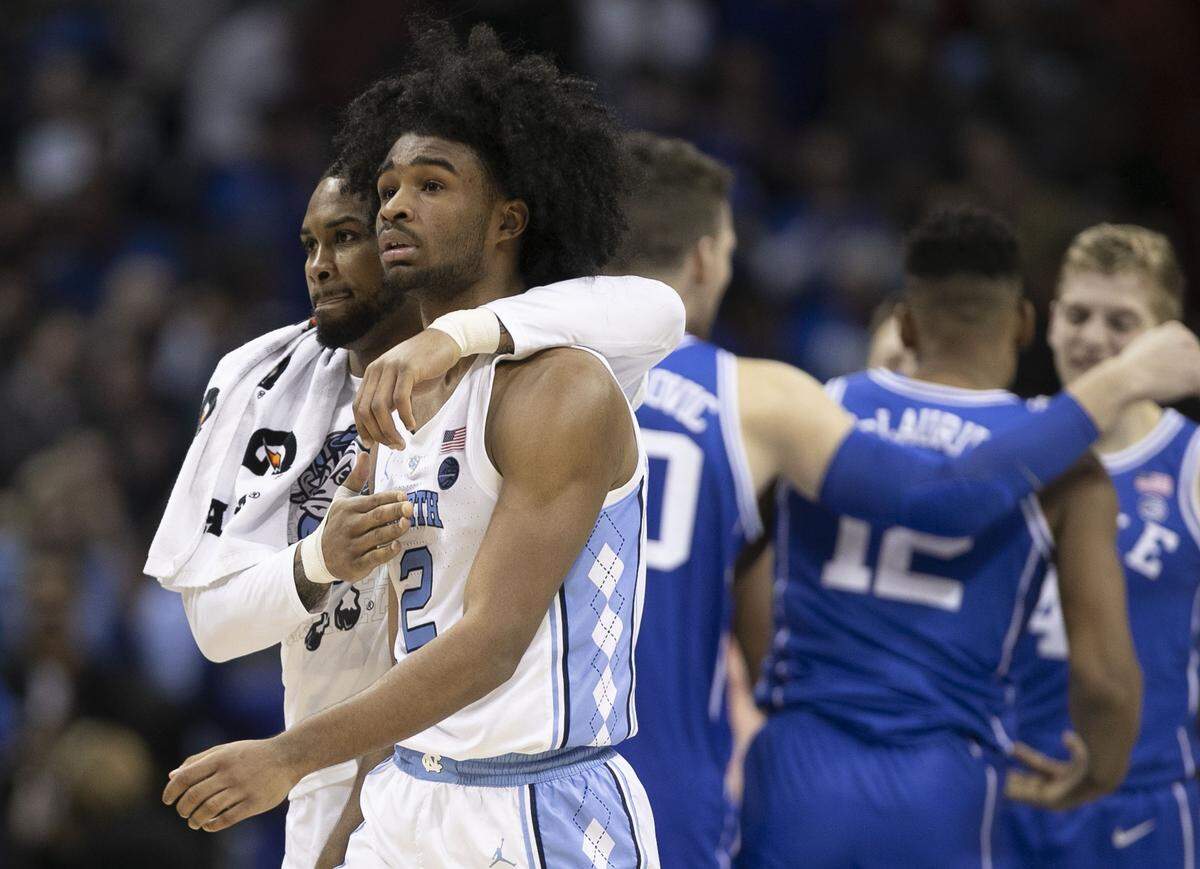 North Carolina’s Seventh Woods (0) consoles teammate Coby White (2) after White missed a three-point shot with three seconds to go Friday night in Duke ‘s 74-73 victory in an ACC tournament semifinal in Charlotte..