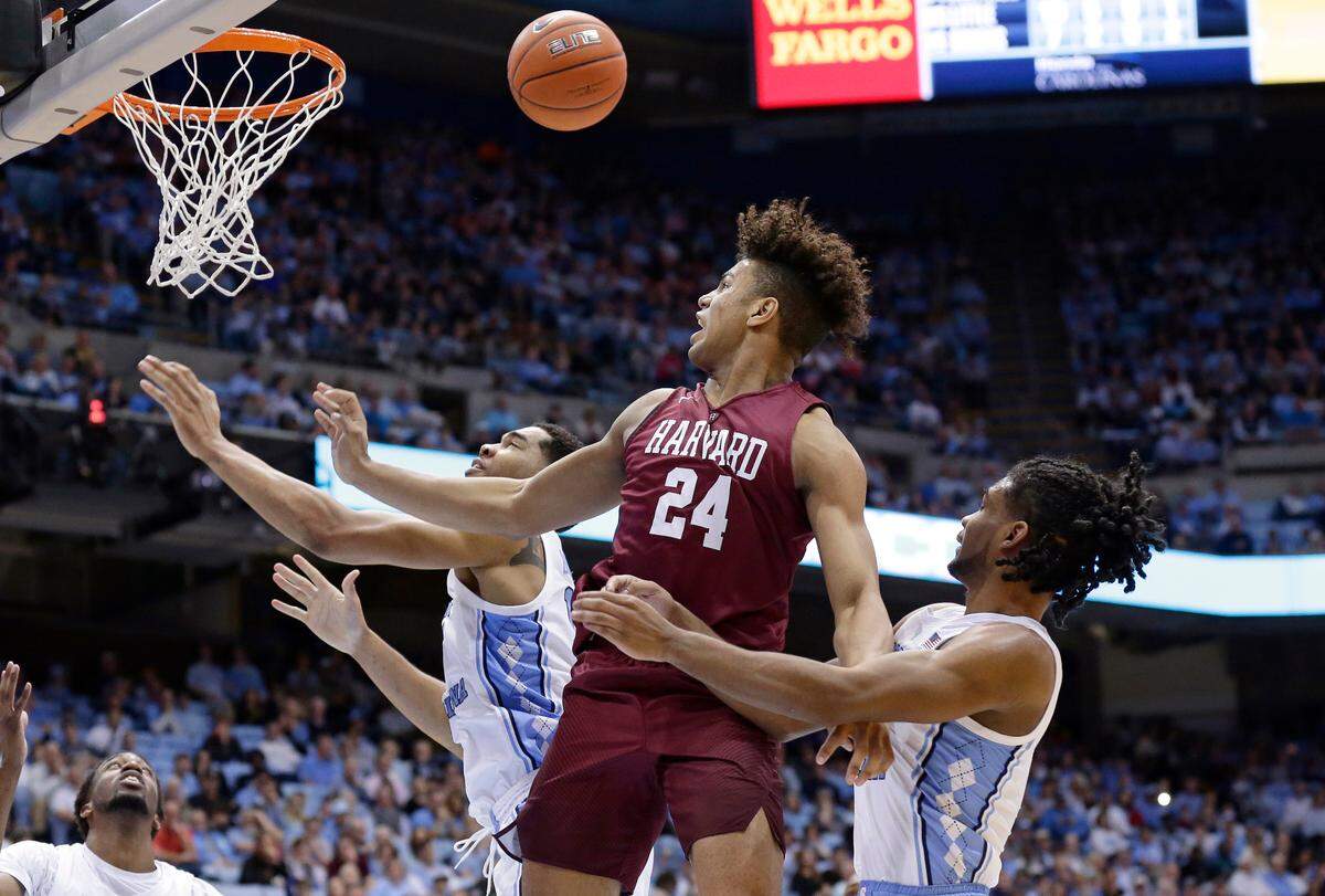 North Carolina’s Garrison Brooks, left, and Coby White defend against Harvard’s Kale Catchings (24) during a game in Chapel Hill, N.C., Wednesday, Jan. 2, 2019.