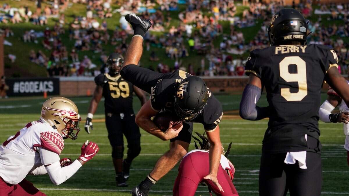 Wake Forest quarterback Sam Hartman, center top, dives into the end zone for a two-point conversion against Florida State during the second half of an NCAA college football game Saturday, Sept. 18, 2021, in Winston-Salem, N.C. (AP Photo/Chris Carlson)