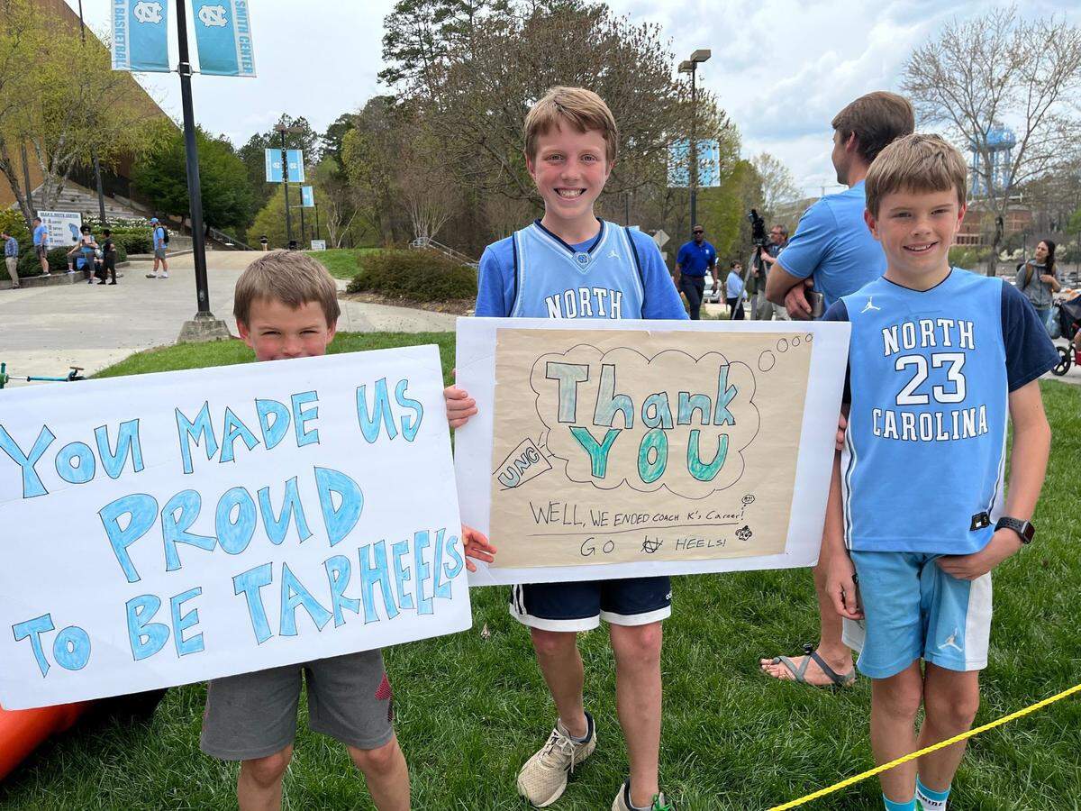 Rence (7), Rob (11) and James Applegate (10) at the Dean E. Smith Center in Chapel Hill on April 5, 2022, to welcome home the UNC men’s basketball team after the team played in the NCAA championship game in New Orleans the night before.