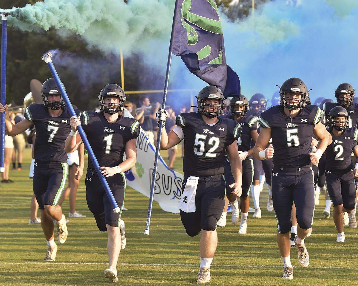Leesville Road’s Cam Todd (52) and the Leesville Road Pride run onto the field before their game with Panther Creek. The Leesville Pride and the Panther Creek Catamounts met in a non-conference football game in Raleigh, N.C. on August 27, 2021.