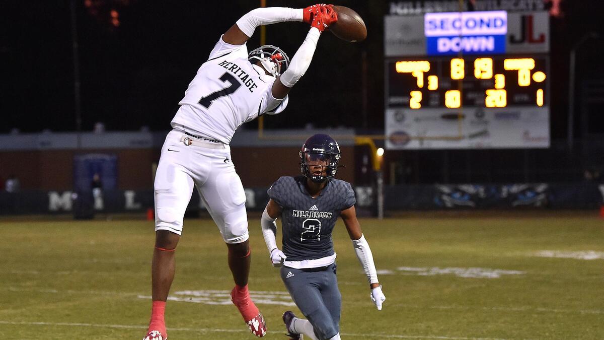 Heritage’s Dwayne Cureton (7) makes the catch over Millbrook’s Chase McClary (2) in the first half. The Millbrook Wildcats and the Heritage Huskies met in a football game in Raleigh, N.C. on September 29, 2022.