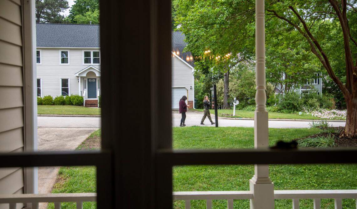 First-time home buyers Carolina Acuipil, left, and Carolina Rancano walk along the front yard of a home for sale in Cary on Thursday, April 27, 2023.