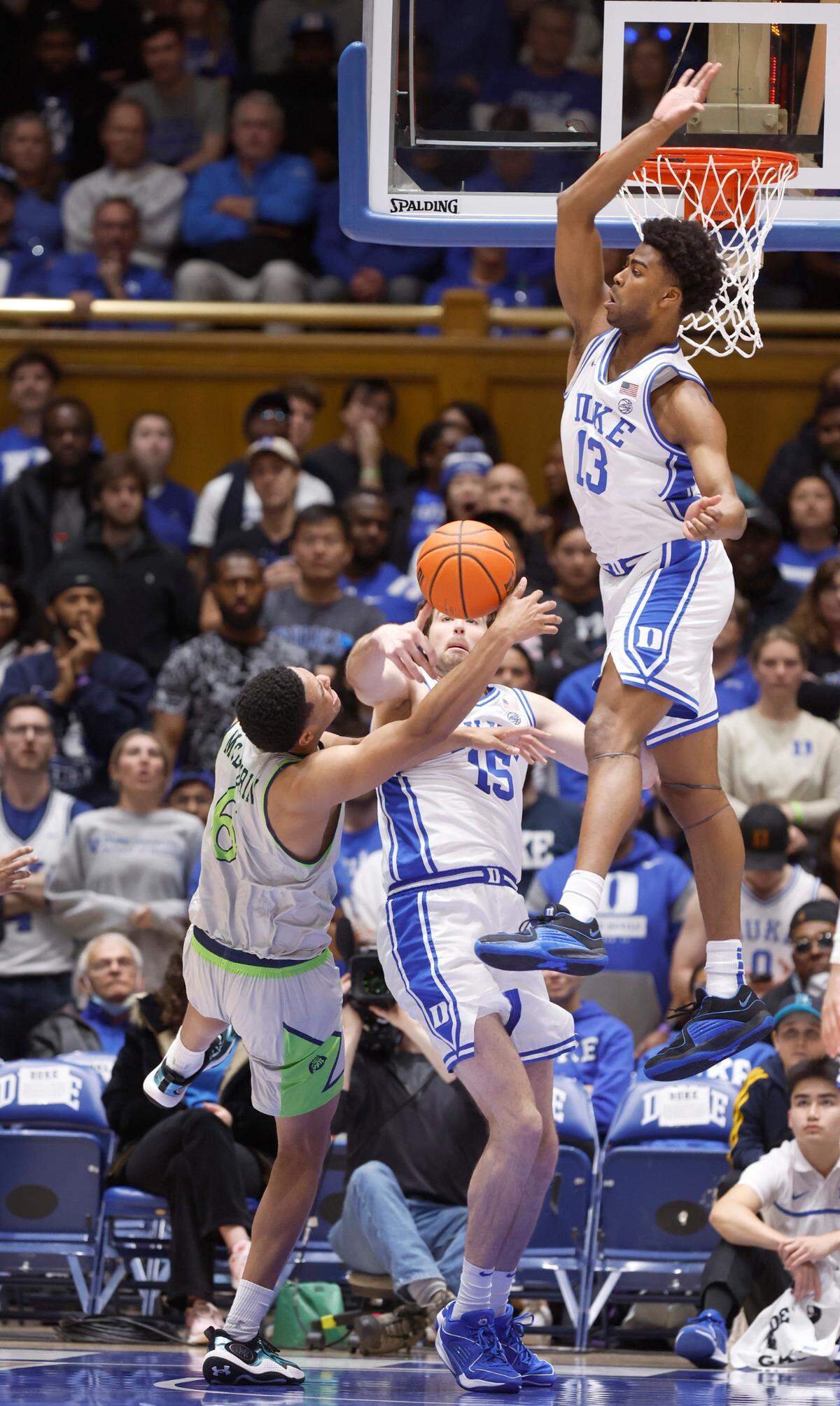 Duke’s Ryan Young (15) and Sean Stewart (13) defend Queens’ BJ McLaurin (6) during the first half of Duke’s game against Queens University at Cameron Indoor Stadium in Durham, N.C., Saturday, Dec. 30, 2023.
