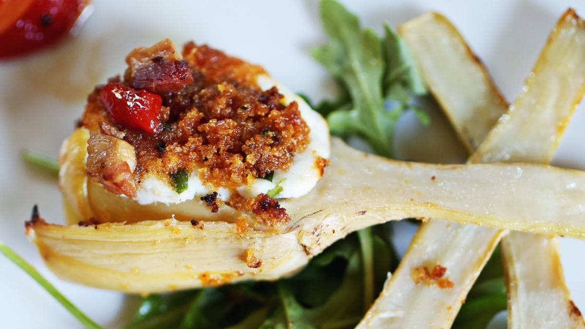 The Carciofi ala Romana are Roman long stem artichokes stuffed with marscarpone and goat cheese with fresh herbs and topped with a pancetta lemon butter sauce at Osteria G in Holly Springs.